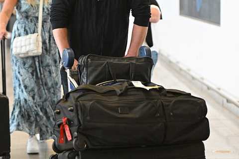 Brendan Fraser smiles at JFK Airport… after breaking down in tears during the Venice premiere of..